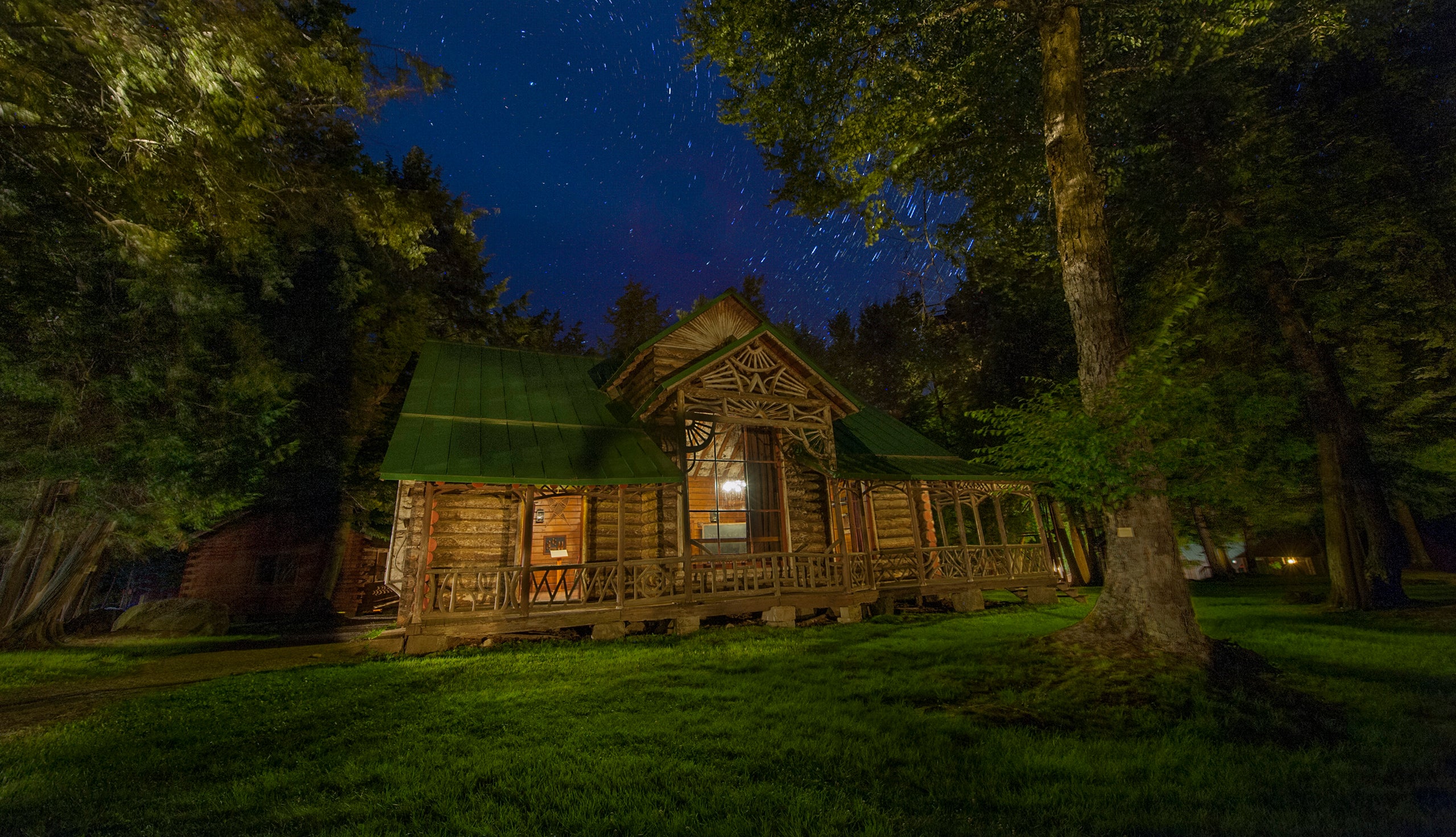 Seen here at night, Great Camp Pine Knot became William West Durant’s most enduring legacy